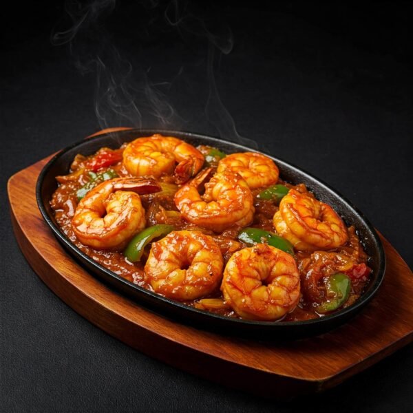 Steaming prawn jalfrazie with bell peppers served on a sizzling platter.